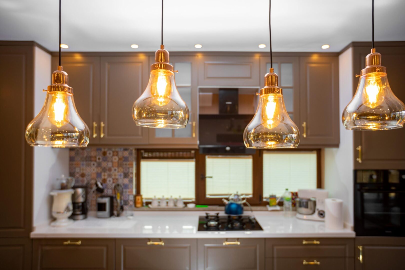 Modern kitchen with hanging pendant lights.